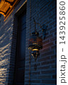 Antique Oriental Metal Lantern Glowing with Warm Amber Light on Brick Wall. Uzbekistan. 143925860