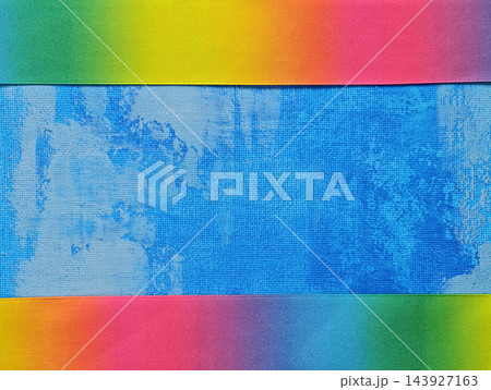 Abstract Blue Canvas Background with Rainbow Fabric Bands Framing Abstract Blue Canvas Background with Rainbow Fabric Bands Framing 143927163