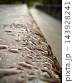 Close up of water droplets on textured concrete surface with blurred background 143928241