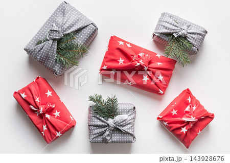 Christmas gifts wrapped in red and grey textile. Christmas gifts wrapped in red and grey textile. 143928676