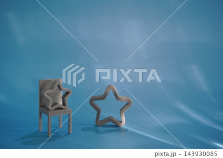 Miniature chair and star symbols set on blue background 143930085