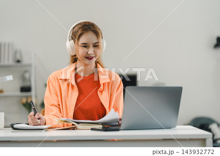 Remote learning of woman studying online with laptop and headphones Remote learning of woman studying online with laptop and headphones 143932772