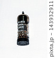 Single Black Vintage Electronic Vacuum Tube on Light Background 143932911