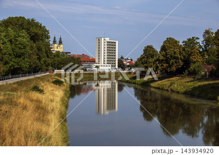 Nitra River with Modern Building Reflection and Tree Lined Banks in Slovakia 143934920