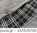 グレーの上着と黒いチェック柄の生地 143936708