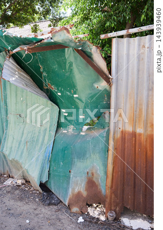 Bent Rusty Metal Fence Damaged by Tropical Weather 143939460
