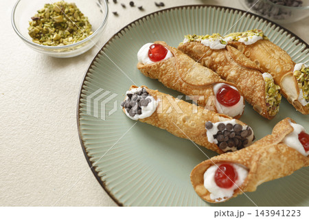 Traditional Sicilian cannoli crispy pastry sweet ricotta cheese dessert plate. Gourmet artisan bakery indulgence premium street food authenticity. Travel gastronomy culinary culture cafe menu food. Traditional Sicilian cannoli crispy pastry sweet ricotta cheese dessert plate. Gourmet artisan bakery indulgence premium street food authenticity. Travel gastronomy culinary culture cafe menu food. 143941223