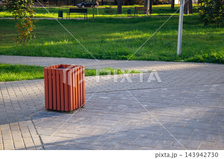 Wooden sorting trash bin in public park on autumn day symbolizing ecology and zero waste lifestyle copy space Wooden sorting trash bin in public park on autumn day symbolizing ecology and zero waste lifestyle copy space 143942730