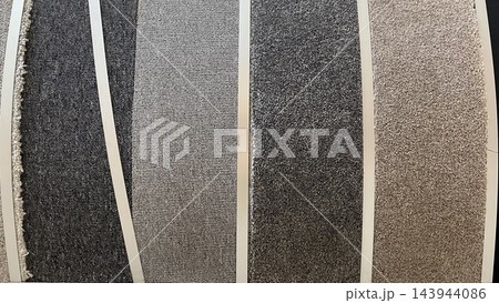Assorted carpet flooring samples in gray, beige and brown colors with different textures displayed at home improvement store Assorted carpet flooring samples in gray, beige and brown colors with different textures displayed at home improvement store 143944086