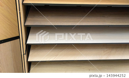 Wood effect flooring samples in different colors, shades and textures displayed in home improvement store Wood effect flooring samples in different colors, shades and textures displayed in home improvement store 143944252