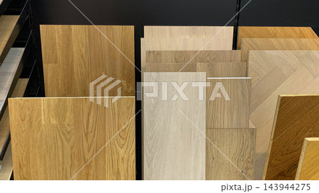 Wooden flooring samples in different natural oak shades and patterns displayed in home improvement store Wooden flooring samples in different natural oak shades and patterns displayed in home improvement store 143944275