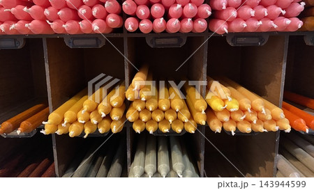 Colorful handmade taper candles arranged by color in craft shop display Colorful handmade taper candles arranged by color in craft shop display 143944599