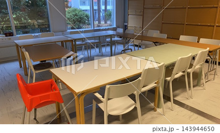 Empty classroom with tables and chairs arranged for group learning and education 143944650