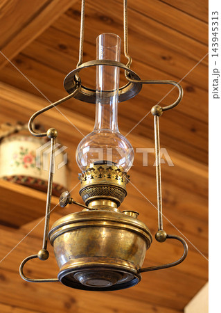 Antique Hanging Kerosene Oil Lamp with Glass Chimney and Brass Metal Frame Antique Hanging Kerosene Oil Lamp with Glass Chimney and Brass Metal Frame 143945313