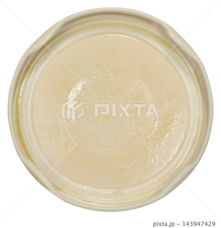 Light jar lid with traces of sauce, mayonnaise, or cream, inside view. Light jar lid with traces of sauce, mayonnaise, or cream, inside view. 143947429
