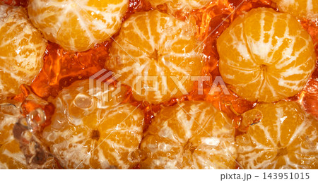 Juicy tangerines in water ripples, orange background 143951015