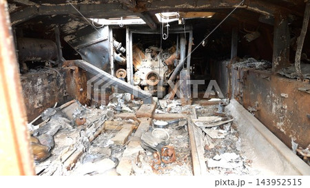 Burned-out and rusty russian armored vehicles displayed at an outdoor exhibition of destroyed military equipment. Damaged transport on ukrainian territory showcasing devastating reality of war 143952515
