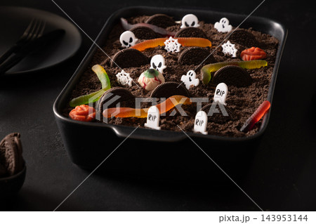 Halloween Dirt Cake graveyard dessert with gummy worms and candy ghosts Halloween Dirt Cake graveyard dessert with gummy worms and candy ghosts 143953144