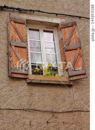 Rustic Window with Wooden Shutters and Flowers Rustic Window with Wooden Shutters and Flowers 143953188