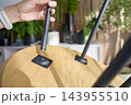 Hand attaching metal leg to wooden table during furniture assembly 143955510