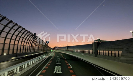 夕焼け空に三日月が浮かぶ夕暮れの高速道路 143956700