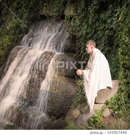Young guy at old waterfall 143957449
