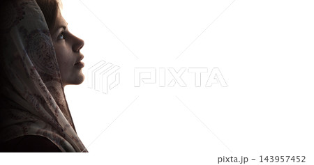 Young girl with bible praying to God Young girl with bible praying to God 143957452