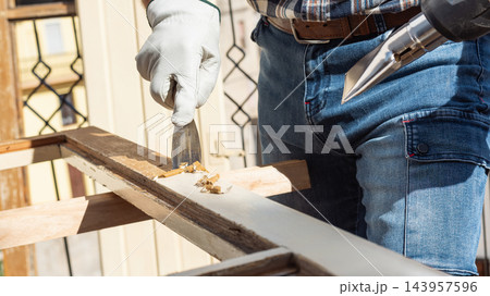 Carpenter at work, restoring an old wooden window. Carpentry. Carpenter at work, restoring an old wooden window. Carpentry. 143957596