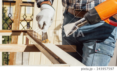 Carpenter at work, restoring an old wooden window. Carpentry. Carpenter at work, restoring an old wooden window. Carpentry. 143957597