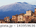 Old houses of Centuripe in front of snowcapped Mount Etna volcano, Sicily, Italy 143959636
