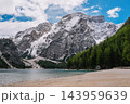 Majestic snowy Croda del Becco mountain above Lake Braies sandy shore, Dolomites, Italy 143959639