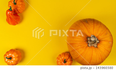 Bright orange pumpkins on a yellow background for autumn celebration 143960380