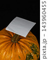 Pumpkin with blank note on top for autumn celebration or decoration 143960455