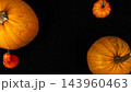 Pumpkins of various sizes on black background for Halloween season 143960463