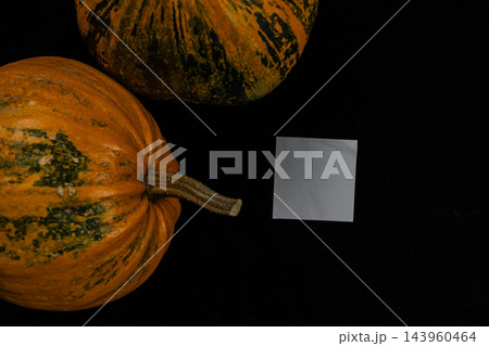 Pumpkins on a dark surface in celebration of Halloween and autumn harvest Pumpkins on a dark surface in celebration of Halloween and autumn harvest 143960464