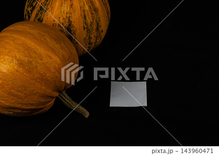 Pumpkins sit on a black surface for Halloween decoration in October Pumpkins sit on a black surface for Halloween decoration in October 143960471