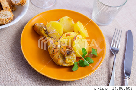 Chicken thigh served with potatoes on dinner plate 143962603