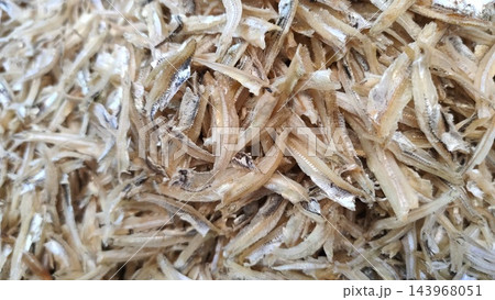Dried small anchovies piled as food ingredient 143968051