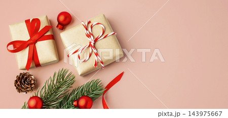 Christmas background with gift boxes and xmas ornaments on pink background, top view 143975667