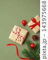 Gift boxes and christmas ornaments on green background, top view 143975668