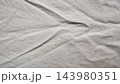 wrinkled white linen fabric texture detail revealing organic cotton weave folds for minimalist background design overlay authentic raw material aesthetic sustainable fashion concept art direction 143980351
