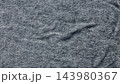 macro heathered charcoal knit fabric texture displaying a soft organic fold and intricate weave pattern for sustainable apparel branding and minimalist web design background evoking tactile warmth and 143980367