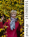 Happy senior woman in pink coat smiling outdoors in autumn park. Active elderly lifestyle, healthy aging and seasonal wellness concepts. Happy senior woman in pink coat smiling outdoors in autumn park. Active elderly lifestyle, healthy aging and seasonal wellness concepts. 143980591