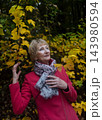 Happy senior woman in pink coat smiling outdoors in autumn park. Active elderly lifestyle, healthy aging and seasonal wellness concepts. Happy senior woman in pink coat smiling outdoors in autumn park. Active elderly lifestyle, healthy aging and seasonal wellness concepts. 143980594