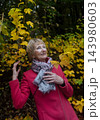 Happy senior woman in pink coat smiling outdoors in autumn park. Active elderly lifestyle, healthy aging and seasonal wellness concepts. Happy senior woman in pink coat smiling outdoors in autumn park. Active elderly lifestyle, healthy aging and seasonal wellness concepts. 143980603