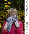 Happy senior woman in pink coat smiling outdoors in autumn park. Active elderly lifestyle, healthy aging and seasonal wellness concepts. Happy senior woman in pink coat smiling outdoors in autumn park. Active elderly lifestyle, healthy aging and seasonal wellness concepts. 143980608