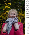 Happy senior woman in pink coat smiling outdoors in autumn park. Active elderly lifestyle, healthy aging and seasonal wellness concepts. Happy senior woman in pink coat smiling outdoors in autumn park. Active elderly lifestyle, healthy aging and seasonal wellness concepts. 143980609