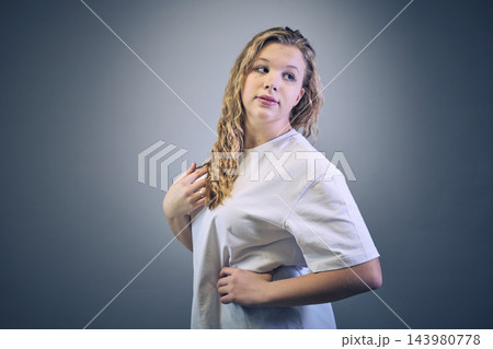 Studio portrait of a girl in casual clothing Studio portrait of a girl in casual clothing 143980778
