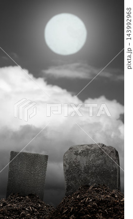 Spooky cemetery scene with two blank gravestones on freshly dug earth under a glowing full moon and dramatic cloudy night sky. Spooky Halloween horror background 143992968