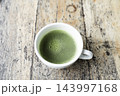 Matcha in a white cup top view on grunge wooden table 143997168